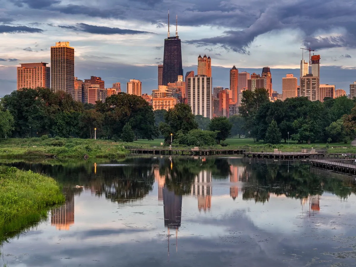 Chicago skyline with trees reflected off North Pond in Lincoln Park